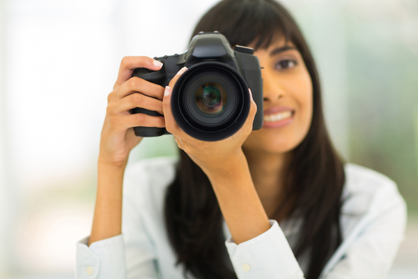 female photographer taking photos with digital camera